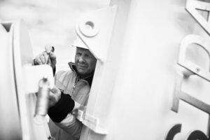 A Vestdavit service engineer on task onspecting and doing service on davit system