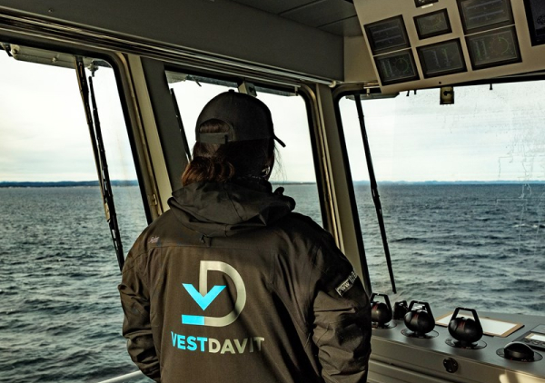 Photo of person wearing a jacket with a vestdavit logo on the back
