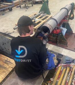 Photo of a vestdavit employee conductgion service on a davit system part