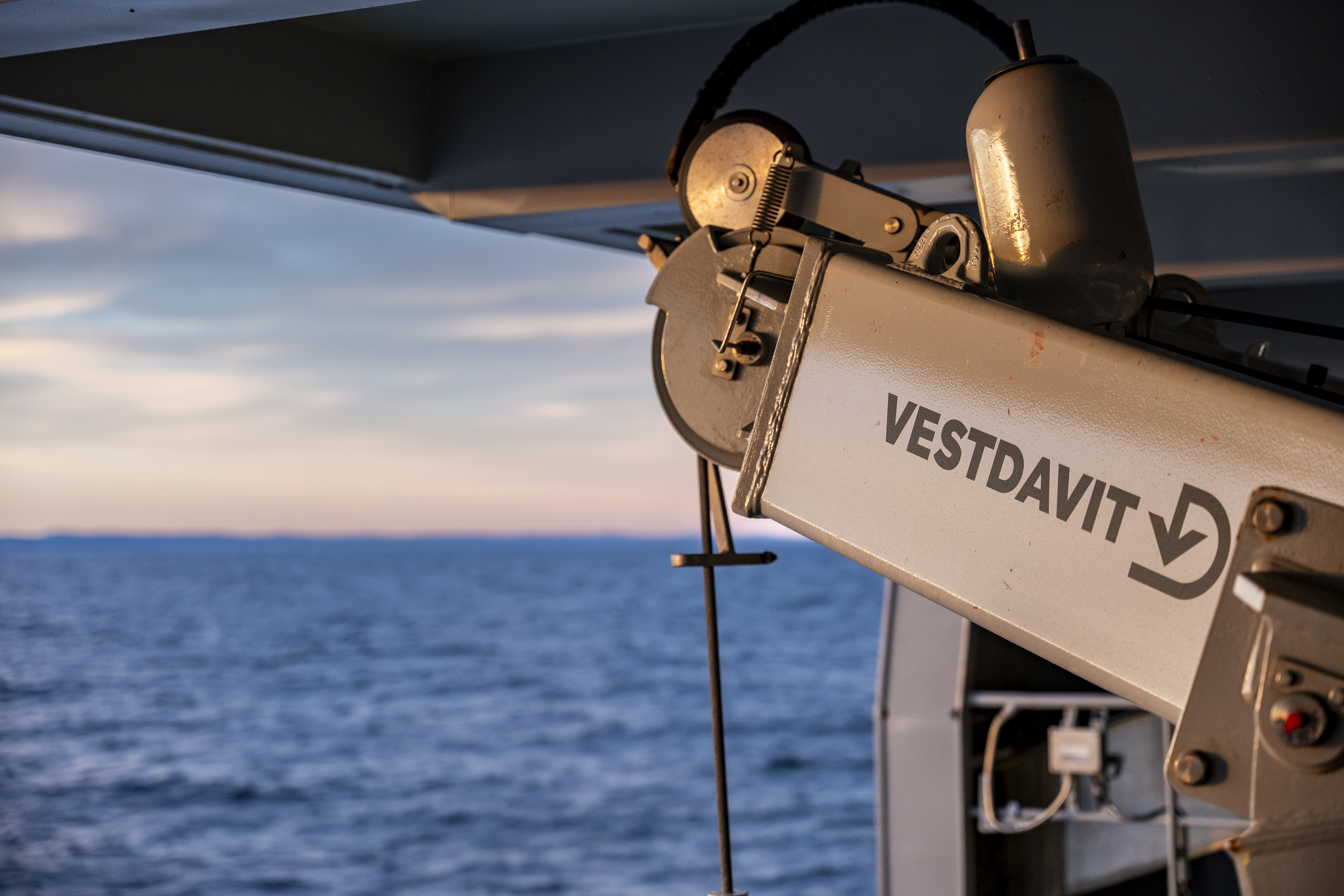 A photo of a winch that is part of a davit system onboard a vessel